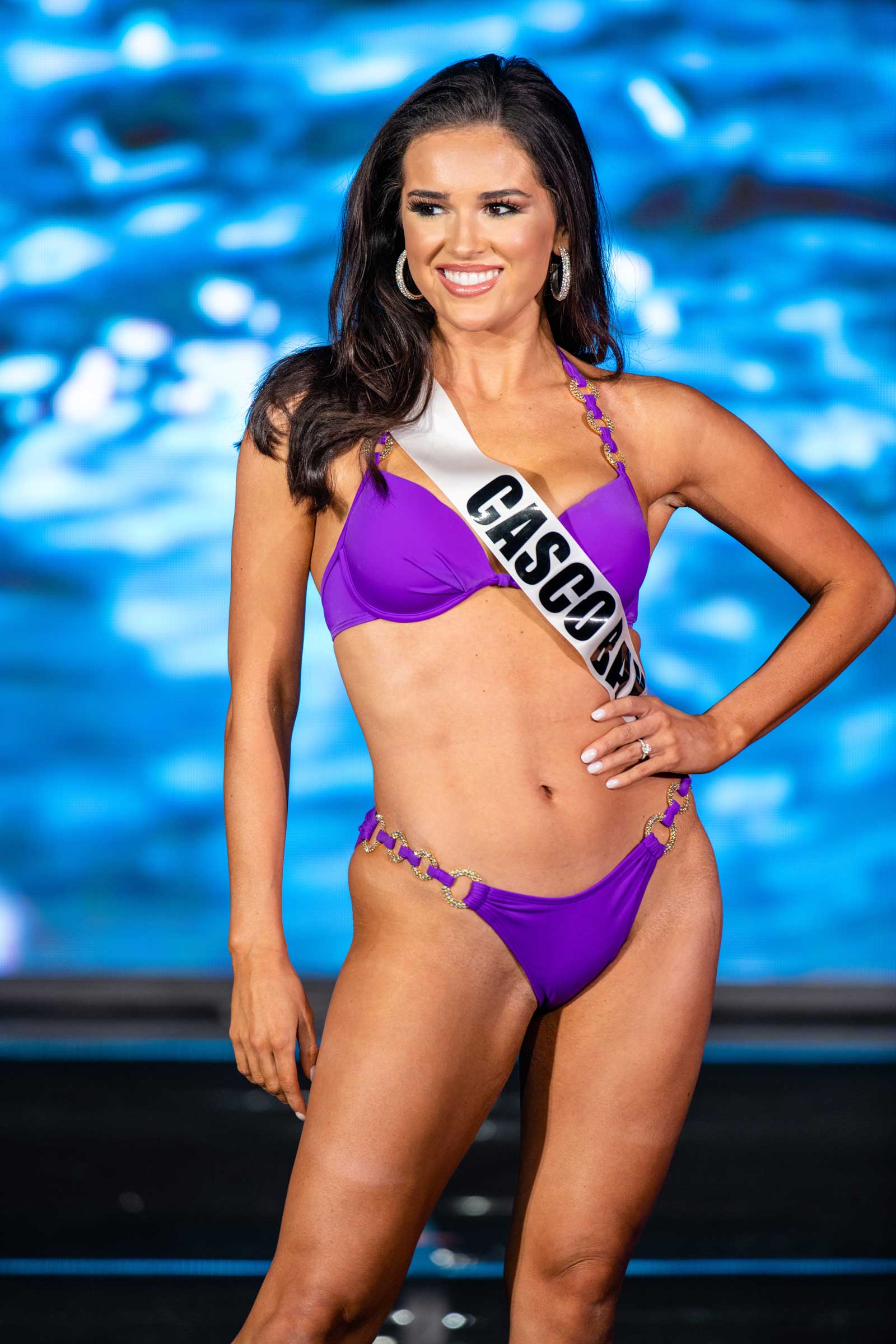 A woman competing in a swimsuit on stage