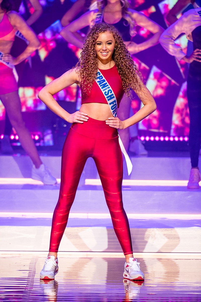 A teenager wearing activewear on a stage